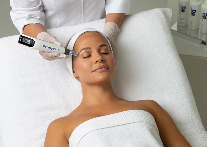 Dr Katey using the DermaPen during a microneedling treatment at her clinic in the Yarra Valley.