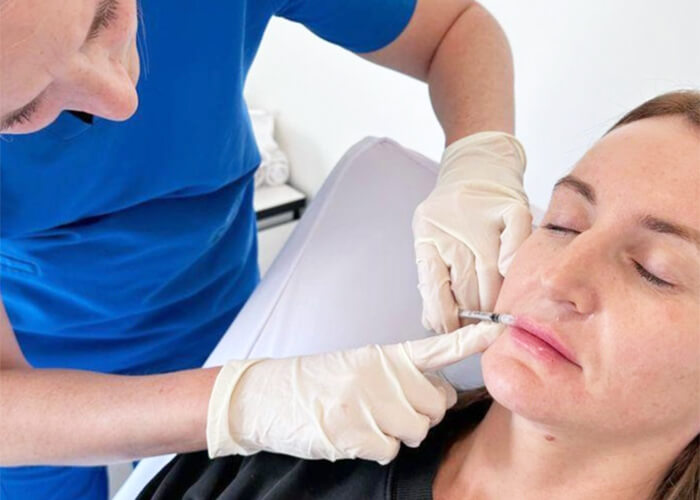 Dr Katey administering a cosmetic injectable treatment to her patient at the clinic in Healesville.