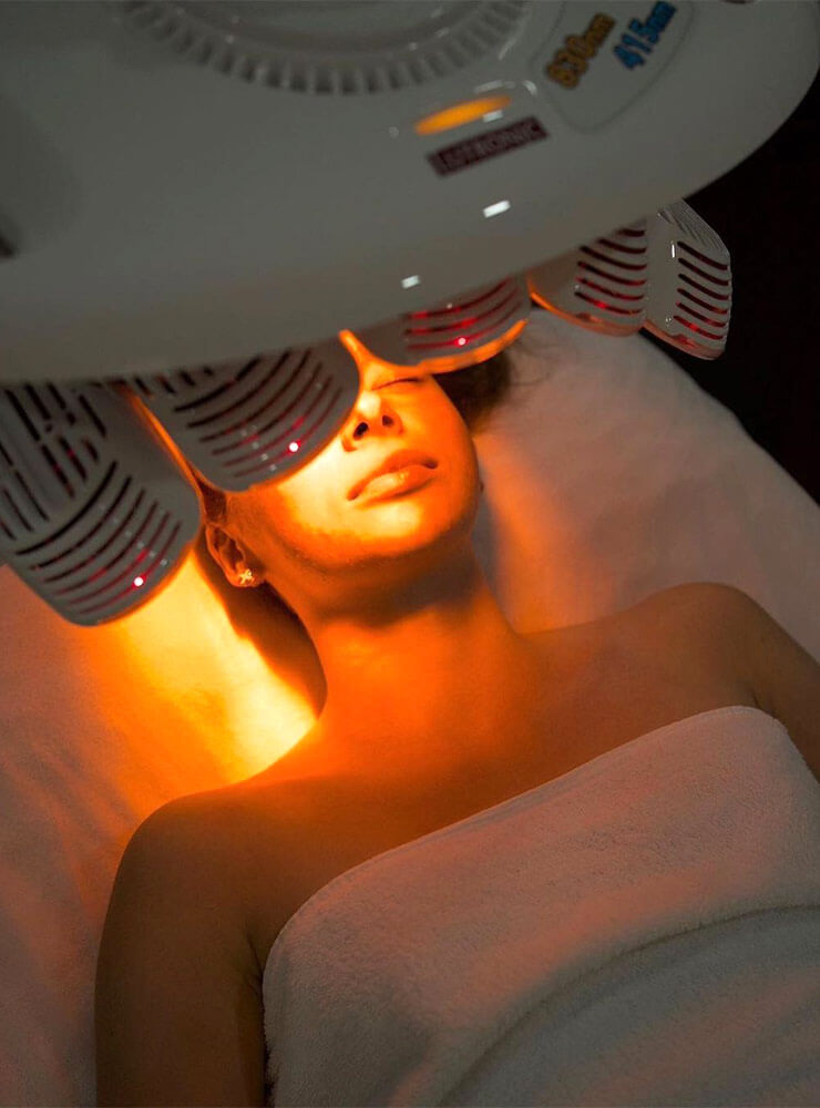 Woman having Healitell LED light therapy skin treatment at Dr Katey Cosmetics.