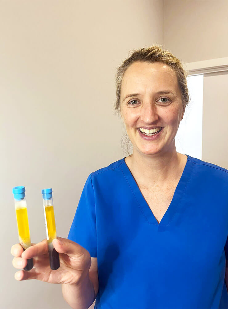 Dr Katey holding medical prp tubes at her skin clinic in Healesville.